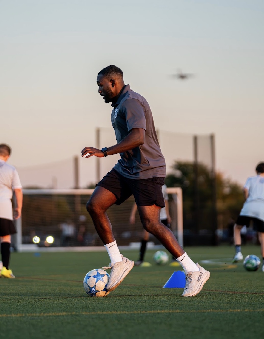 AB Technical Training coach guiding a group of youth soccer players